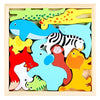 A wooden tangram puzzle board featuring colorful, cutout shapes of various animals like a fish, tiger, and hedgehog.