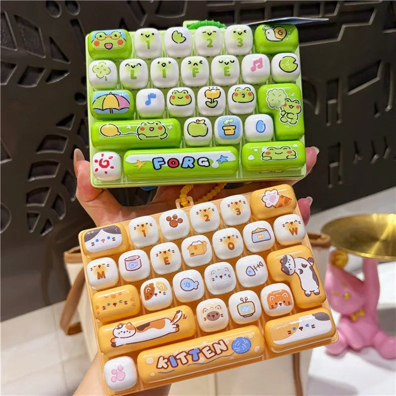 A set of colorful cartoon animal keycap keychains arranged in a grid, held by a hand.