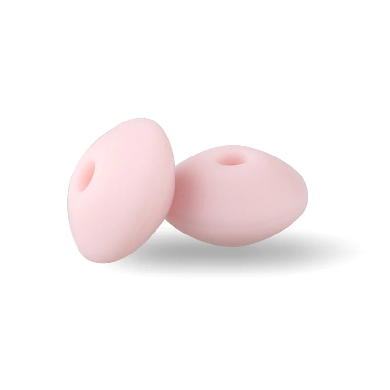 Two pink silicone lentil beads shaped like an abacus for jewelry making