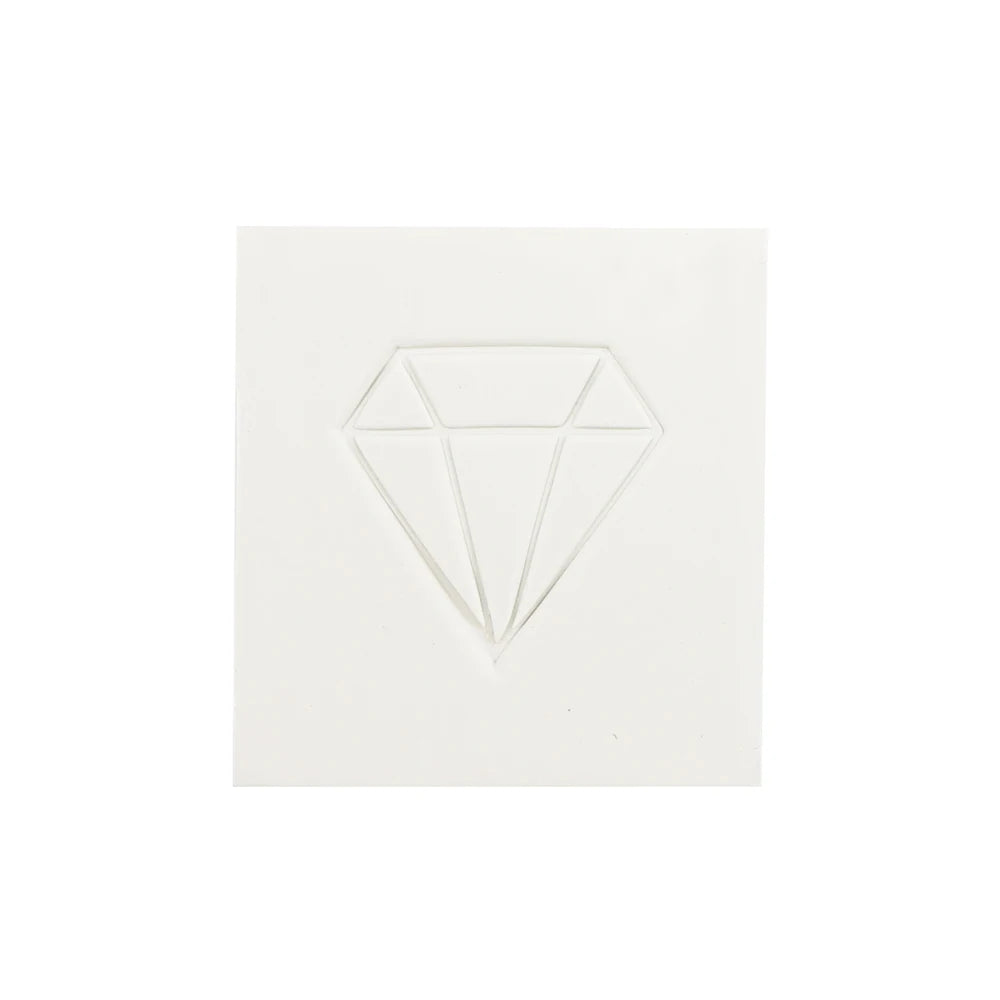 A clear, faceted diamond shape made of wax used for crafting and diamond painting.