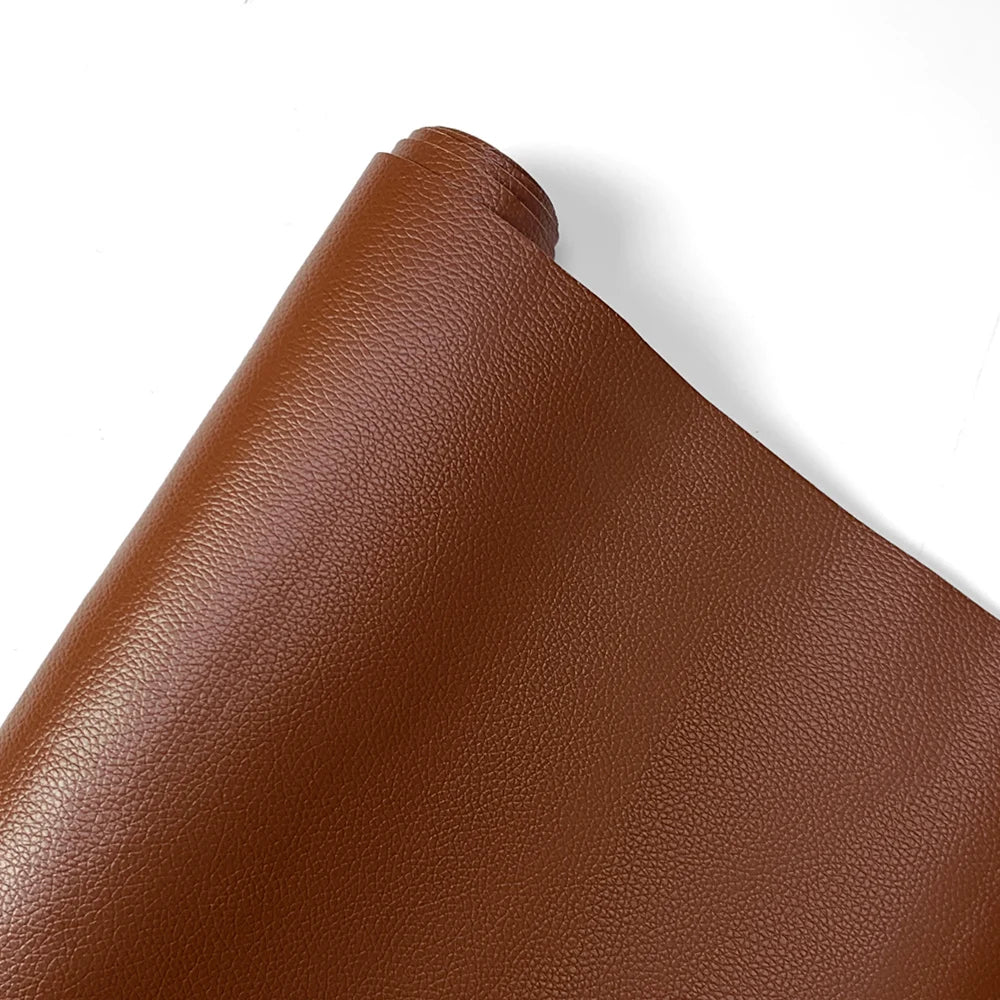 A close-up view of a brown PU leather self-adhesive repair patch.