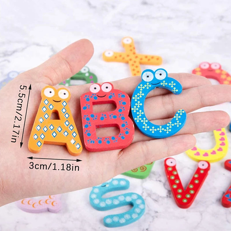 Wooden magnetic alphabet letters A, B, and C in orange, red, and blue colors shown in a hand