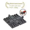 A gray big brick track board with interlocking pieces and a small red train model.