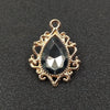 Gold plated water droplet charm featuring a faceted dark crystal gemstone set in an ornate flower design