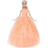 A female doll wearing an elegant peach colored evening gown with gold embroidery and a sweetheart neckline.
