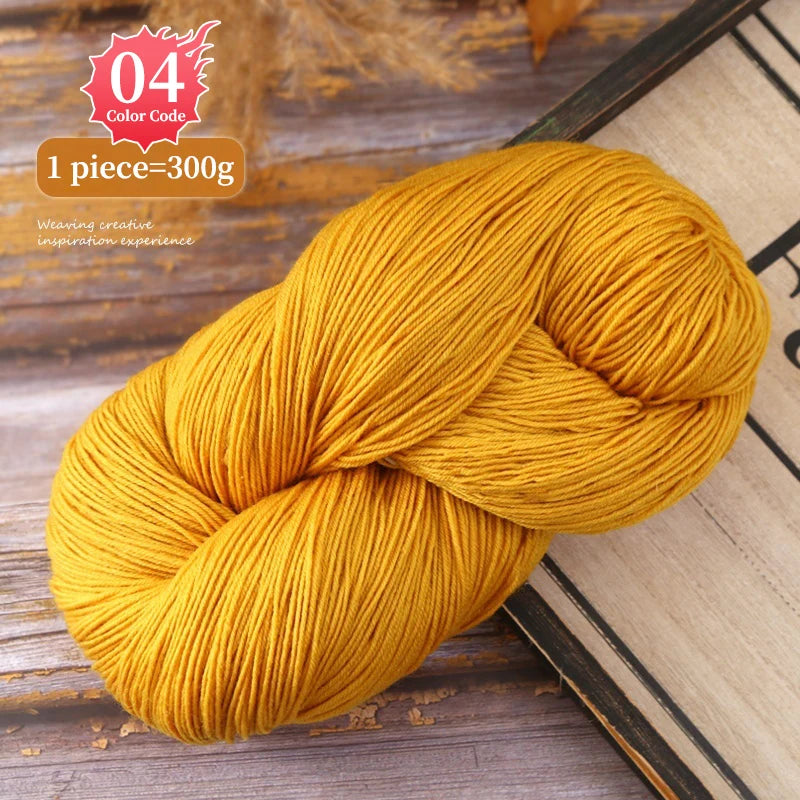 A ball of bright golden yellow yarn used for knitting or weaving, shown next to a book.
