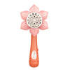 An orange electric bubble blower toy shaped like a pink sunflower with a perforated head.