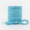 A roll of teal velvet faux suede braided ribbon used for crafting and gift wrapping.