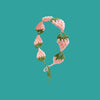 A handmade strawberry crochet headband in pink and green yarn against a teal background.