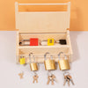 A wooden lock and key toy set with various sized keys and locks displayed in a light wooden box.