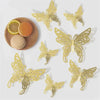 Rose gold 3D butterfly wall stickers displayed with a slice of citrus and a round object.