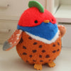 An orange and blue cartoon bird plush with a green crest, sitting on a white surface.