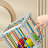 A white Montessori shape sorter cube filled with colorful rings and shapes, demonstrating its durable design.