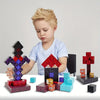A young boy is shown interacting with various colored magnetic building cubes and stacking blocks.