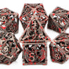A set of blood dragon metal dice for tabletop role-playing games featuring intricate red and black designs.