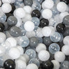 A close-up view of a mixed pack of clear and opaque white, gray, and black plastic play balls.