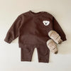 A brown baby long sleeve cartoon top and pants set featuring a white bear design.