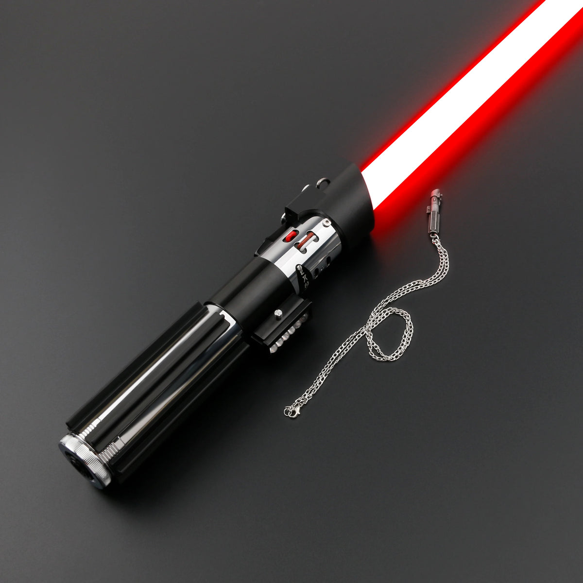 A black lightsaber with a red blade and a chain attached, shown against a dark background.
