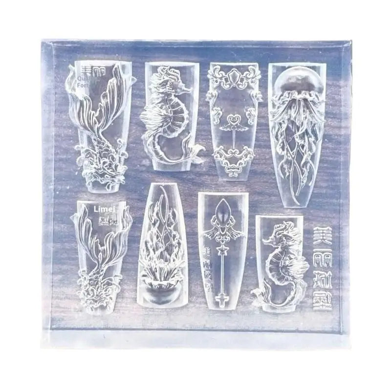A clear silicone mold featuring intricate sea shell, starfish, and ocean designs for nail art.