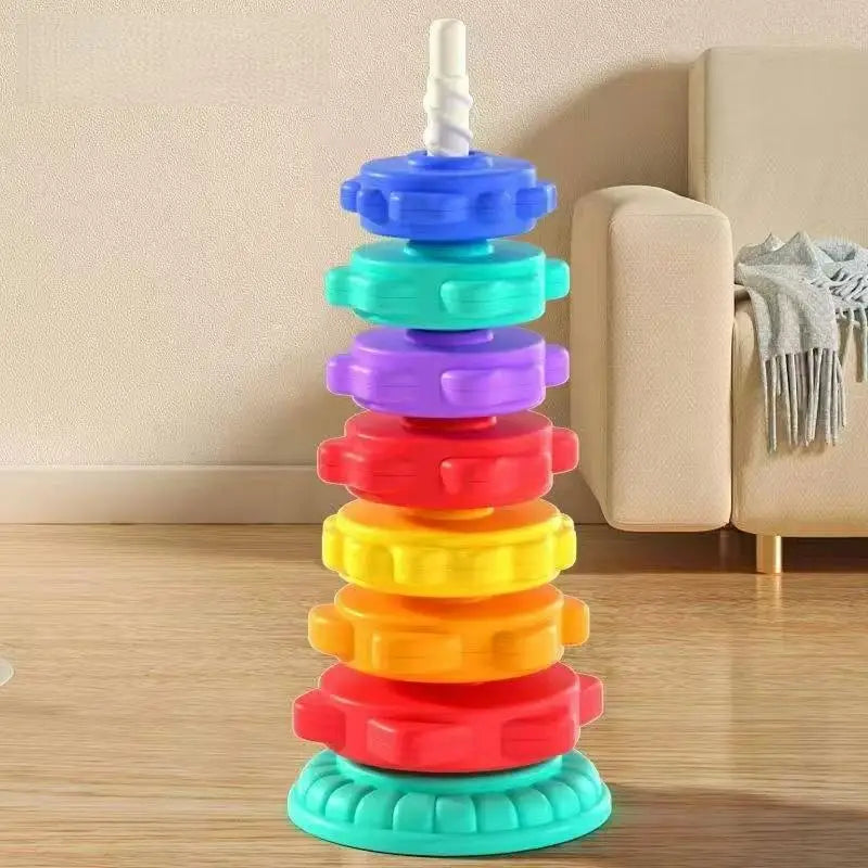 A colorful stacking tower made of rings in rainbow colors, used for motor skill development.