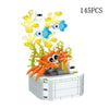 An orange rose flower building block bouquet set featuring various colored flowers and leaves.