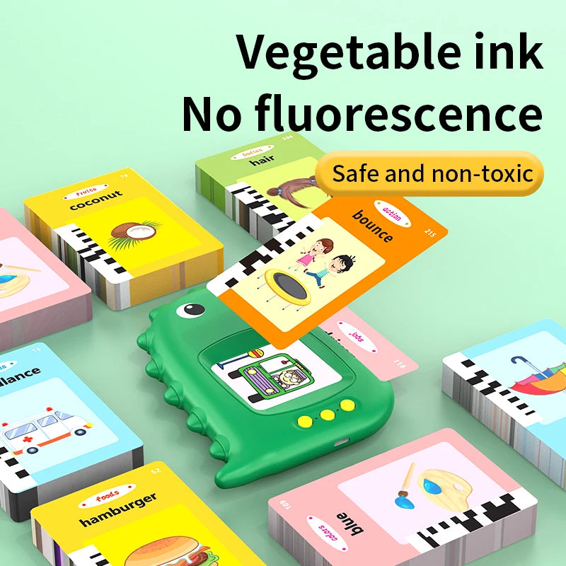 A colorful interactive talking flash card learning machine with various food and object cards shown on a light green backgrou