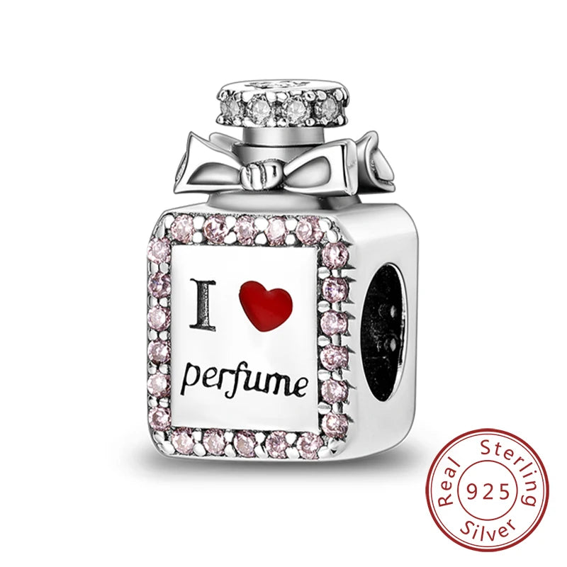 A silver locket charm featuring a heart design and the word perfume set in a decorative box.