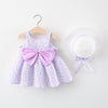 A purple floral baby girl summer dress and sunhat set with pink bow details displayed on a hanger.