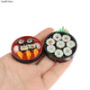 A hand holds a small bowl of miniature Japanese sushi, including nigiri and maki rolls, for a dollhouse kitchen set.