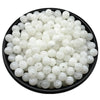 A pile of small, round, translucent white acrylic beads for jewelry making.