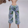 A light blue knitted long-sleeved garment for a doll featuring green leafy patterns.