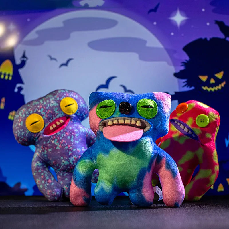 A colorful plush monster doll with big teeth and a tongue, displayed against a dark background.