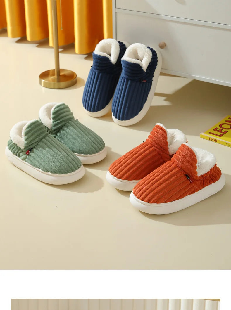 A collection of women's cozy faux fur slippers in navy blue, olive green, and burnt orange colors displayed on a light surfac