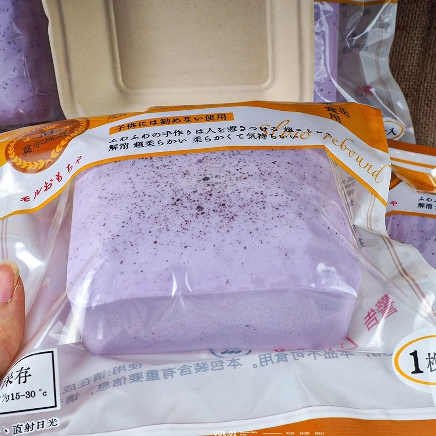 A purple slow-rise toast squishy stress relief toy packaged in clear plastic.