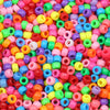 A close-up view of a large pile of multicolor pony beads in various bright colors for jewelry making and crafts.