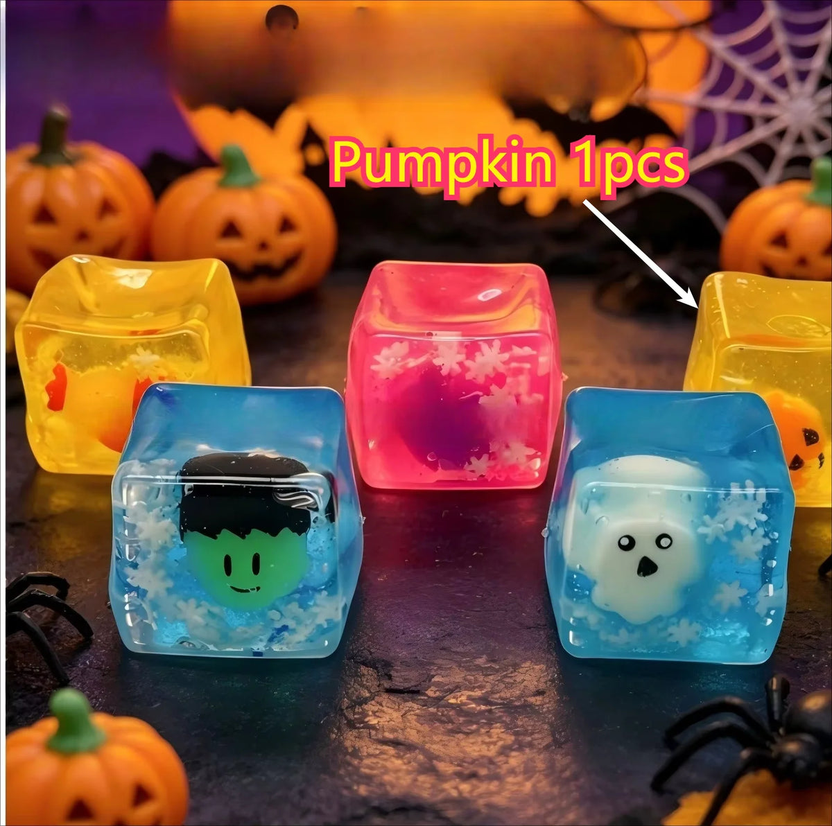 A set of four translucent squishy toys shaped like ghosts and pumpkins on a dark surface.