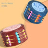 A dark blue puzzle magic wheel and a pink wooden slide puzzle cube for kids.