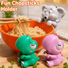 Cute plastic elephant figurines used as a fun chopsticks holder for food