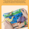 A hand holds a colorful cloth book featuring dinosaur illustrations, demonstrating its durability.