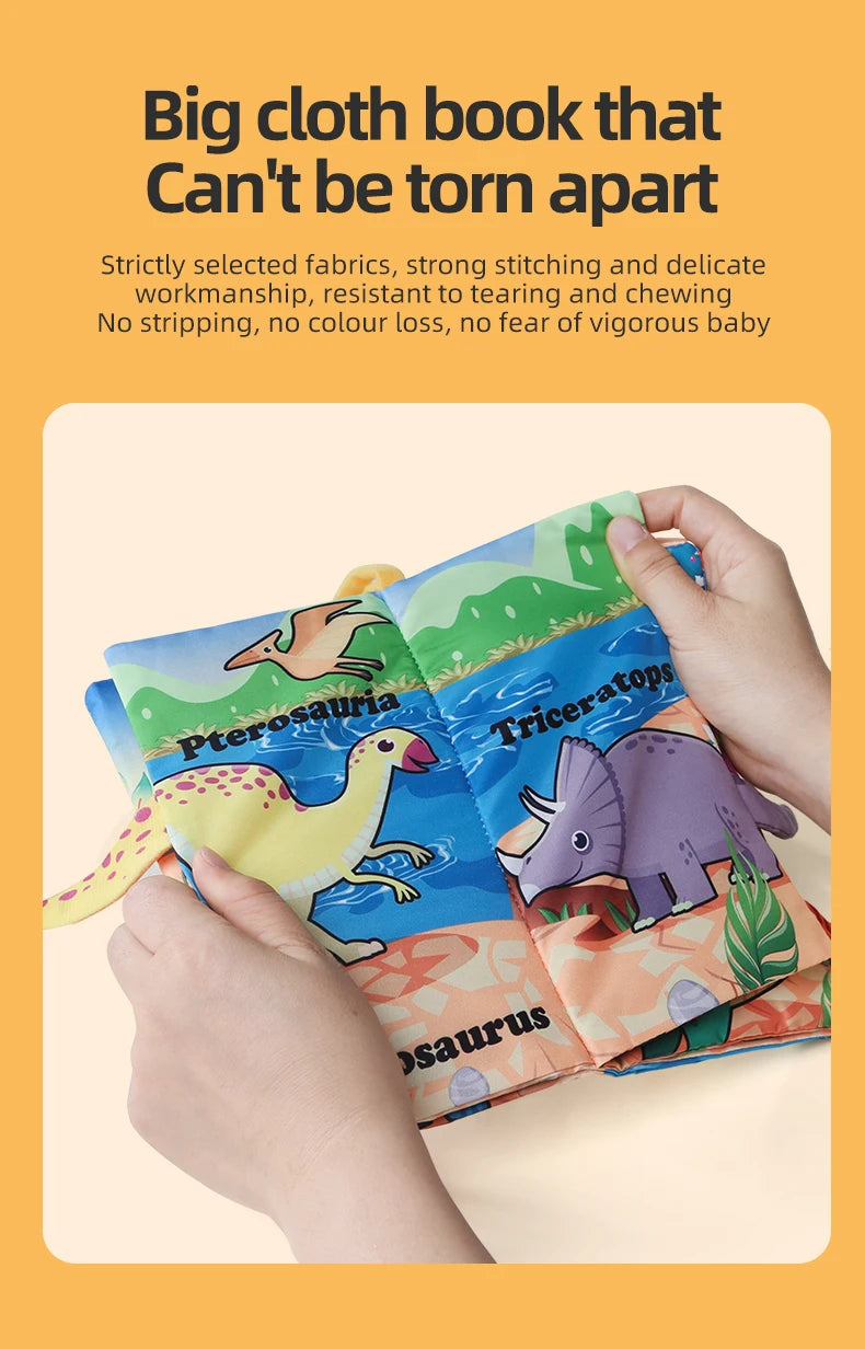 A hand holds a colorful cloth book featuring dinosaur illustrations, demonstrating its durability.