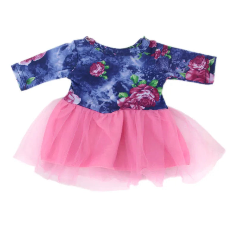A handmade doll dress featuring a dark blue floral print with pink accents and a tulle skirt.