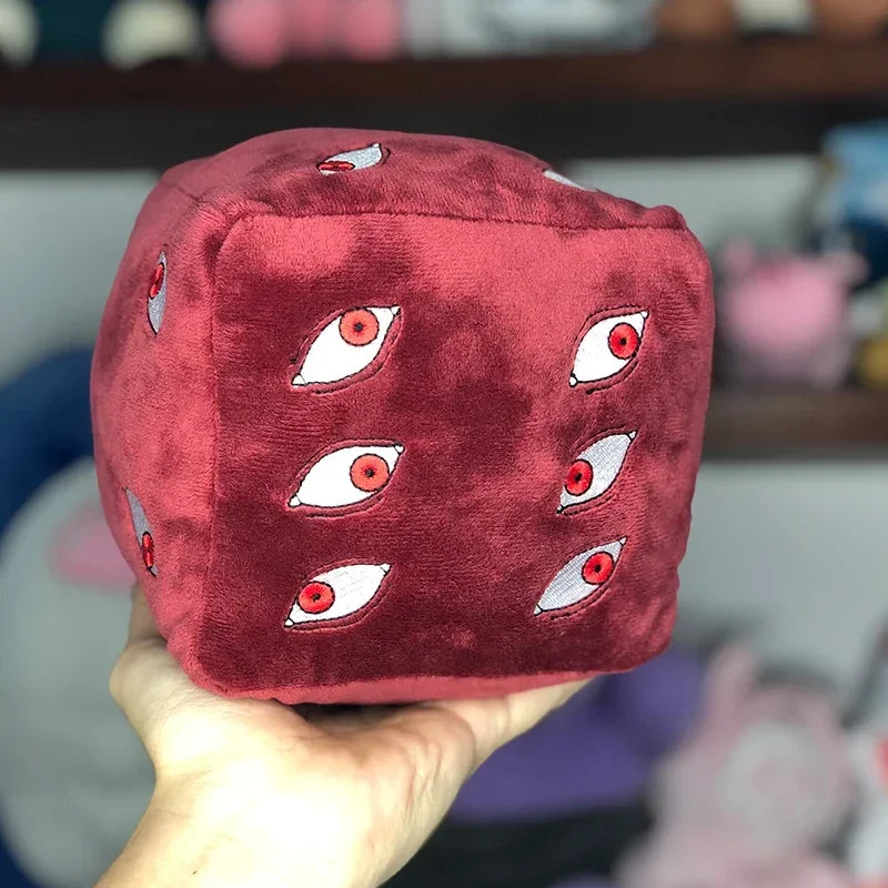 A deep red plush figure of Gojo Satoru with multiple eye designs.