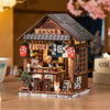 A detailed miniature Japanese izakaya dollhouse kit featuring wooden structures and decorative elements.