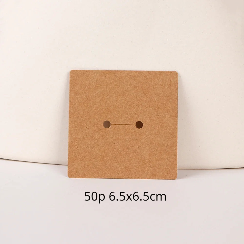 A square brown kraft card with two small holes, used for jewelry display.