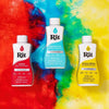 Three bottles of Rit liquid fabric dye in scarlet, aquamarine, and lemon yellow set against a colorful abstract background.
