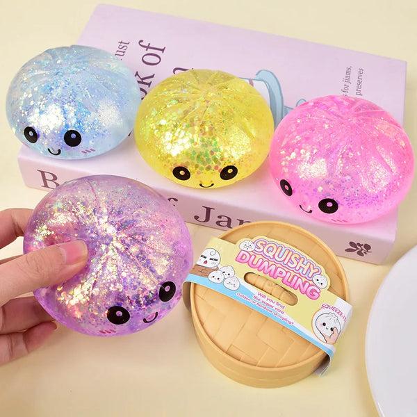 A collection of colorful glitter dumplings squishy toys in various shades including blue, yellow, and pink, displayed next to
