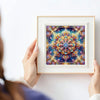 A hand holds a framed piece of colorful mandala abstract canvas art featuring intricate floral patterns.