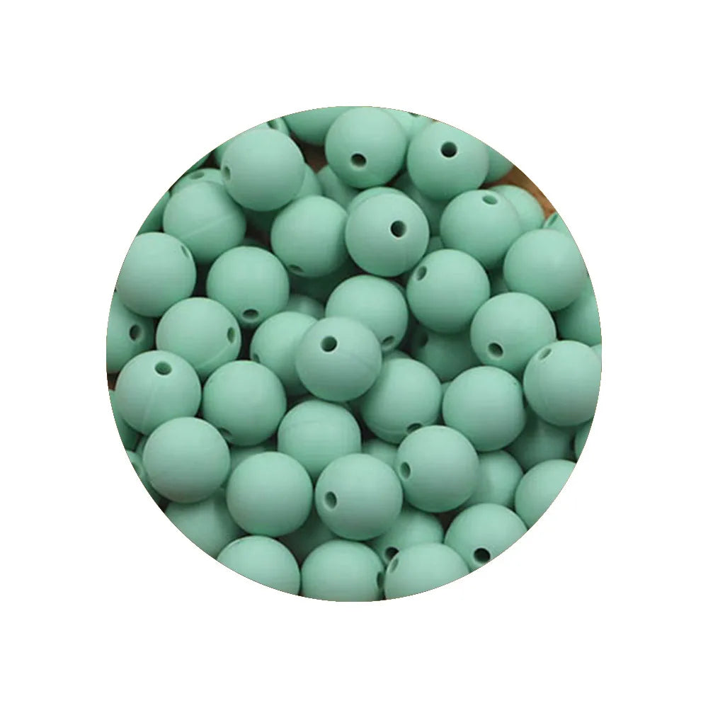 A circular arrangement of 50 silicone beads in various sizes and shades of mint green.