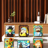 A set of colorful pixel art building blocks featuring various figures and objects like a man, a woman, and a sunflower.