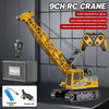 A yellow RC crane truck is shown with a hook, battery, and charging cable on a gray background.